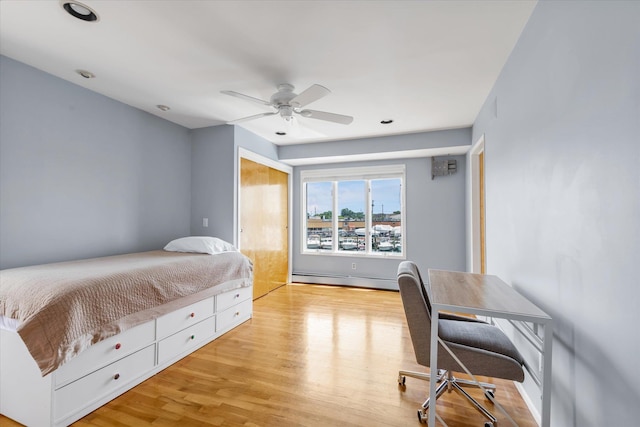 3337 Murdock Ave, Oceanside, NY 11572 - bedroom with baseboard heating, wood finished floors, and ceiling fan