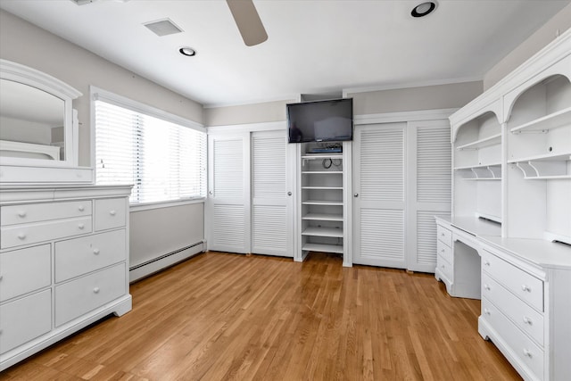 3337 Murdock Ave, Oceanside, NY 11572 - unfurnished bedroom with a baseboard heating unit, two closets, light wood-style flooring, ceiling fan, and recessed lighting