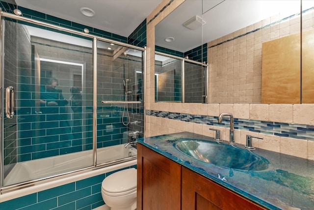 3337 Murdock Ave, Oceanside, NY 11572 - bathroom with tiled shower / bath, tile walls, vanity, decorative backsplash, and recessed lighting