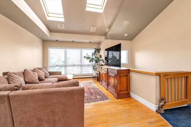 3337 Murdock Ave, Oceanside, NY 11572 - living area with a skylight, light wood-style floors, vaulted ceiling, and baseboard heating