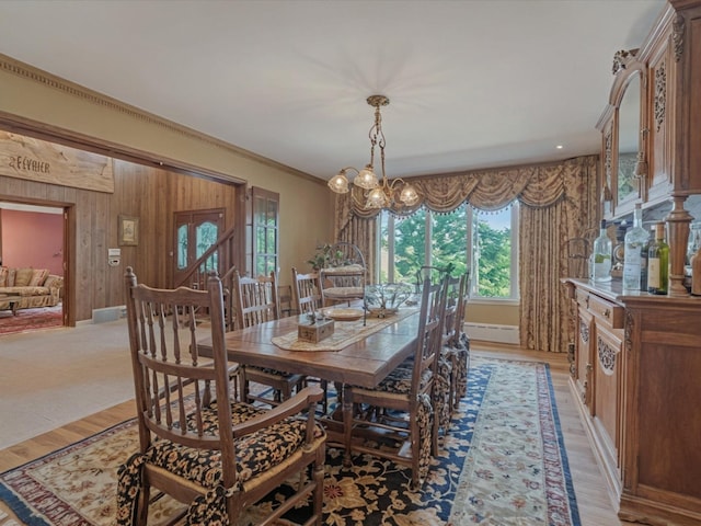 2000 Lake End Rd, Merrick, NY 11566 - dining area with light wood-type flooring, a chandelier, and wood walls