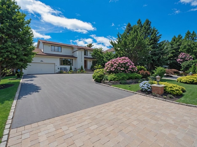 2000 Lake End Rd, Merrick, NY 11566 - view of front facade with asphalt driveway, stucco siding, and an attached garage