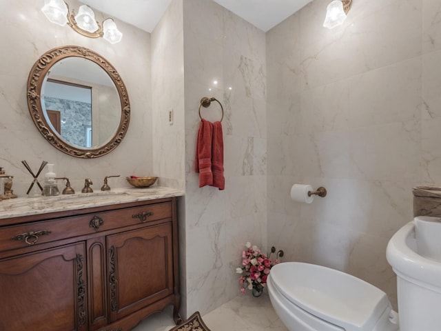 2000 Lake End Rd, Merrick, NY 11566 - bathroom featuring tile walls, marble finish floors, vanity, and a bidet