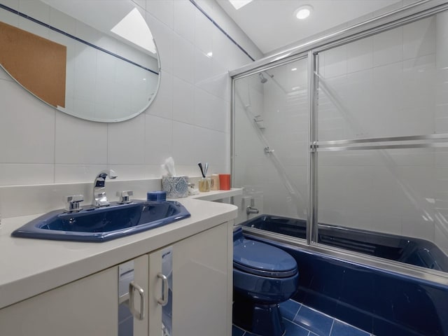 2000 Lake End Rd, Merrick, NY 11566 - full bathroom with tile walls, bath / shower combo with glass door, vanity, decorative backsplash, and tile patterned floors