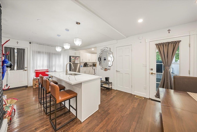 1098 Rte 311, Patterson, NY 12563 - kitchen featuring stainless steel refrigerator, dark wood finished floors, a breakfast bar, white cabinets, and pendant lighting