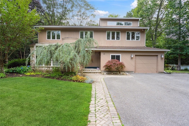 35 Stratford Ave, Dix Hills, NY 11746 - mid-century home featuring a garage, asphalt driveway, and a front yard