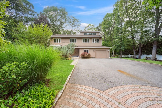 35 Stratford Ave, Dix Hills, NY 11746 - view of front of house featuring driveway, stucco siding, a garage, and a front lawn