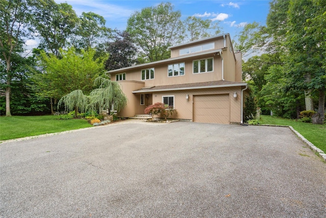 35 Stratford Ave, Dix Hills, NY 11746 - view of front of house featuring an attached garage, asphalt driveway, and a front yard