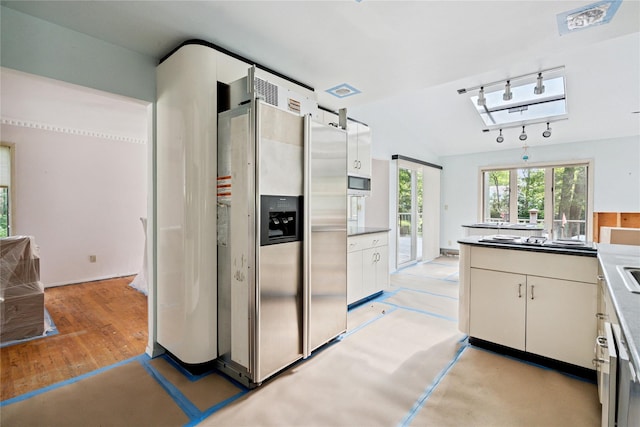 35 Stratford Ave, Dix Hills, NY 11746 - kitchen featuring appliances with stainless steel finishes, white cabinets, track lighting, and lofted ceiling