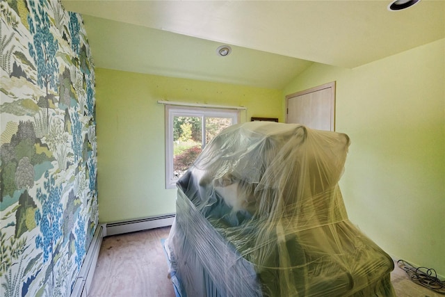 35 Stratford Ave, Dix Hills, NY 11746 - bedroom with wood finished floors, baseboard heating, and vaulted ceiling