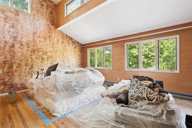 35 Stratford Ave, Dix Hills, NY 11746 - bedroom with multiple windows, hardwood / wood-style floors, and wooden walls