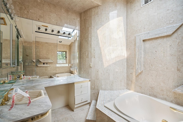 35 Stratford Ave, Dix Hills, NY 11746 - bathroom with tile walls, a bath, vanity, and tile patterned flooring