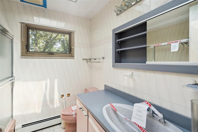35 Stratford Ave, Dix Hills, NY 11746 - full bath featuring a baseboard heating unit, vanity, tile walls, and an enclosed shower