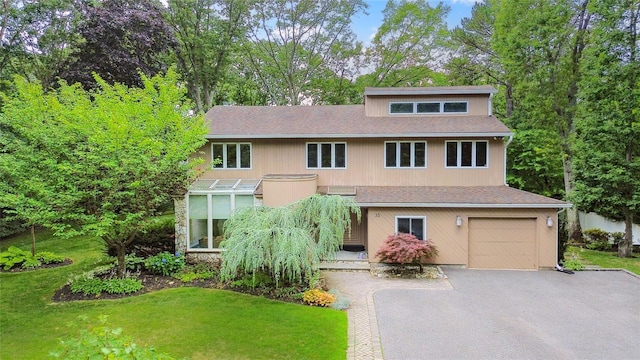 35 Stratford Ave, Dix Hills, NY 11746 - view of front of home with asphalt driveway, a front lawn, an attached garage, and a shingled roof