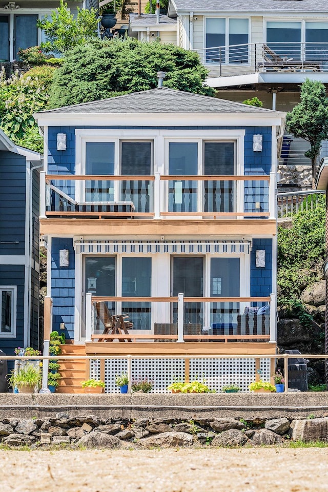 75 W Shore Rd Unit 4, Port Washington, NY 11050 - view of front facade featuring a balcony, a shingled roof, and covered porch