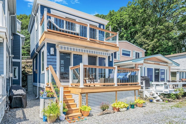 75 W Shore Rd Unit 4, Port Washington, NY 11050 - back of house with a balcony, stairs, a sunroom, and a wooden deck