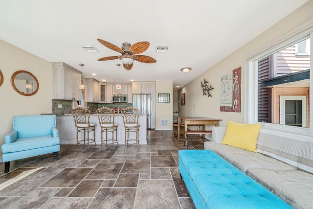 75 W Shore Rd Unit 4, Port Washington, NY 11050 - living room with stone tile flooring, ceiling fan, and recessed lighting