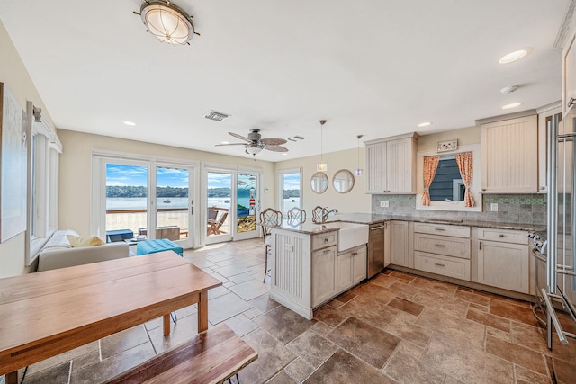 75 W Shore Rd Unit 4, Port Washington, NY 11050 - kitchen with dishwasher, a peninsula, plenty of natural light, backsplash, and recessed lighting
