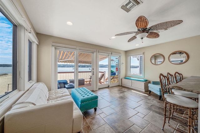 75 W Shore Rd Unit 4, Port Washington, NY 11050 - living area featuring ceiling fan, stone tile flooring, recessed lighting, and a water view