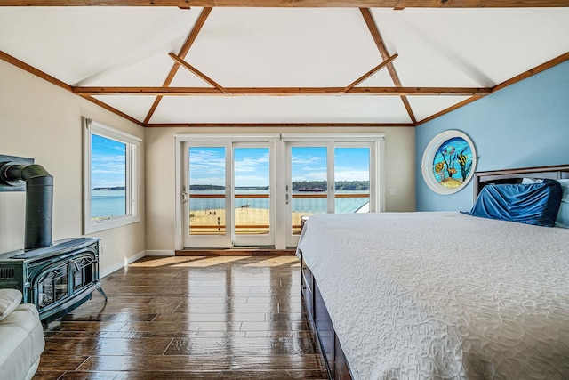 75 W Shore Rd Unit 4, Port Washington, NY 11050 - bedroom with a wood stove, access to exterior, dark wood-style floors, vaulted ceiling, and a water view