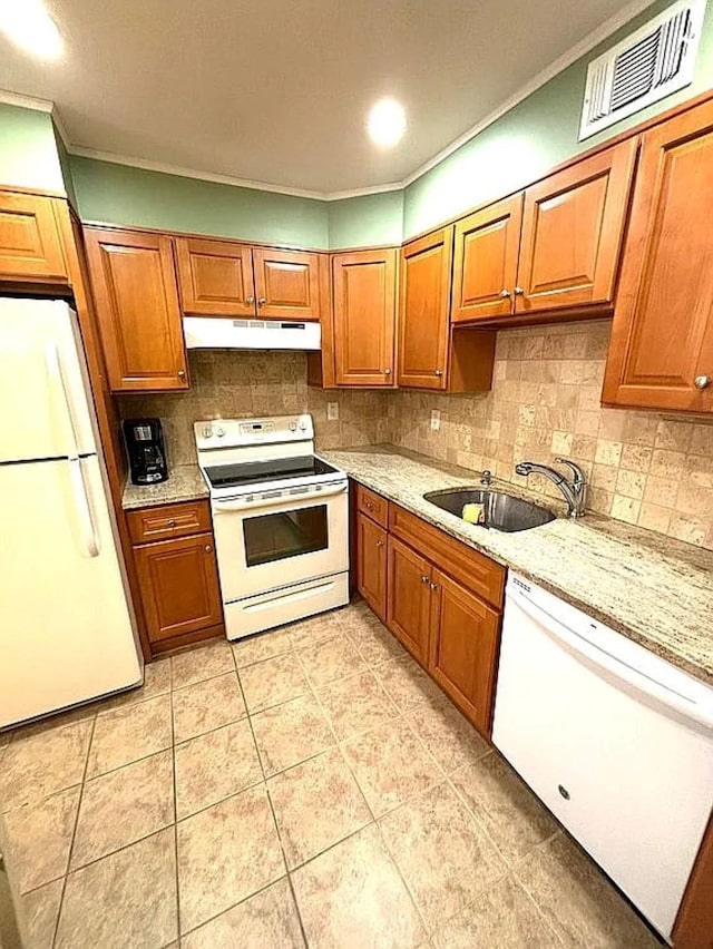 108 Village Rd Unit B, Jefferson Valley, NY 10598 - kitchen with white appliances, under cabinet range hood, brown cabinets, tasteful backsplash, and light tile patterned floors