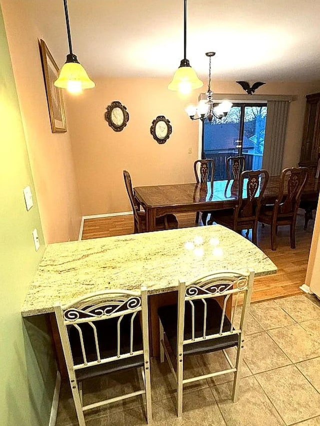 108 Village Rd Unit B, Jefferson Valley, NY 10598 - dining room with a chandelier and light tile patterned floors