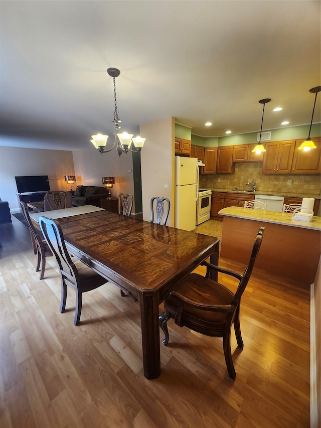 108 Village Rd Unit B, Jefferson Valley, NY 10598 - dining area with light wood-style flooring, a chandelier, and recessed lighting