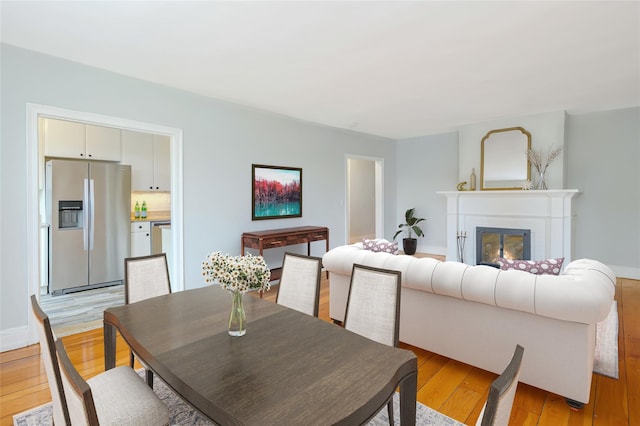 914 Wynnewood Rd Unit 3R, Pelham, NY 10803 - dining room with light wood-style floors and a glass covered fireplace