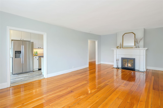 914 Wynnewood Rd Unit 3R, Pelham, NY 10803 - unfurnished living room with light wood-style floors and a fireplace with flush hearth