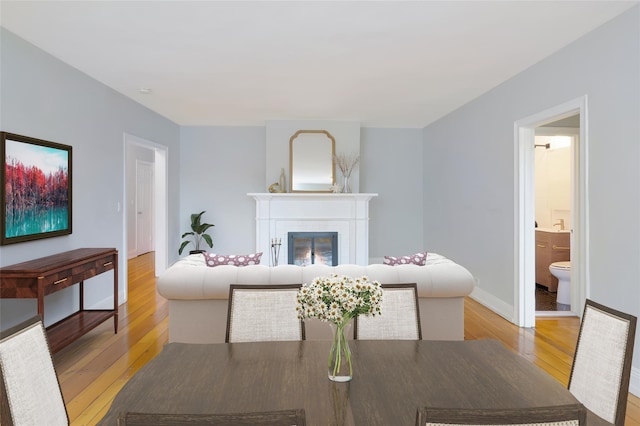 914 Wynnewood Rd Unit 3R, Pelham, NY 10803 - dining space featuring light wood-style floors and a glass covered fireplace