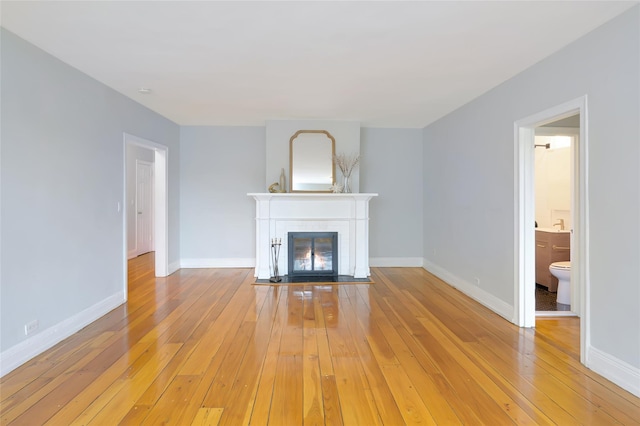 914 Wynnewood Rd Unit 3R, Pelham, NY 10803 - unfurnished living room with light wood-style flooring and a fireplace with flush hearth
