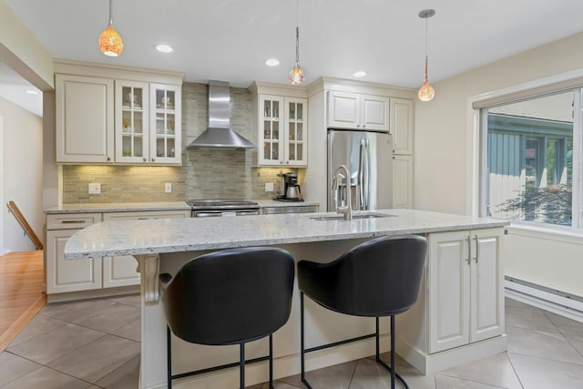 623 Heritage Hls Unit B, Somers, NY 10589 - kitchen featuring wall chimney exhaust hood, stainless steel appliances, a breakfast bar area, light tile patterned flooring, and recessed lighting