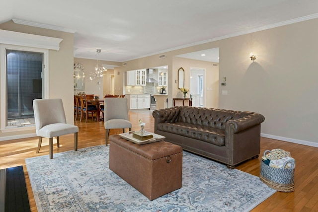 623 Heritage Hls Unit B, Somers, NY 10589 - living room featuring wood finished floors, ornamental molding, and a chandelier