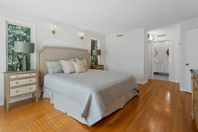 623 Heritage Hls Unit B, Somers, NY 10589 - bedroom with light wood-style flooring, connected bathroom, and ornamental molding