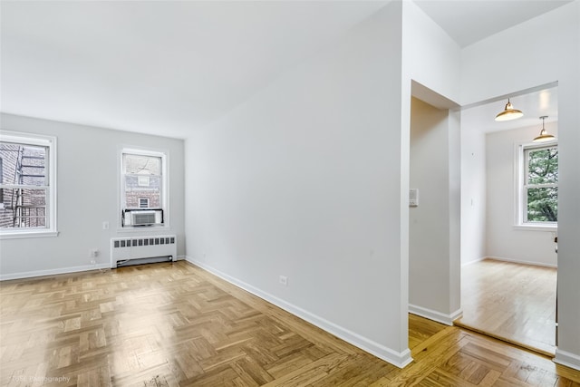 48-55 43rd St Unit 4H, Woodside, NY 11377 - empty room with radiator, healthy amount of natural light, and cooling unit