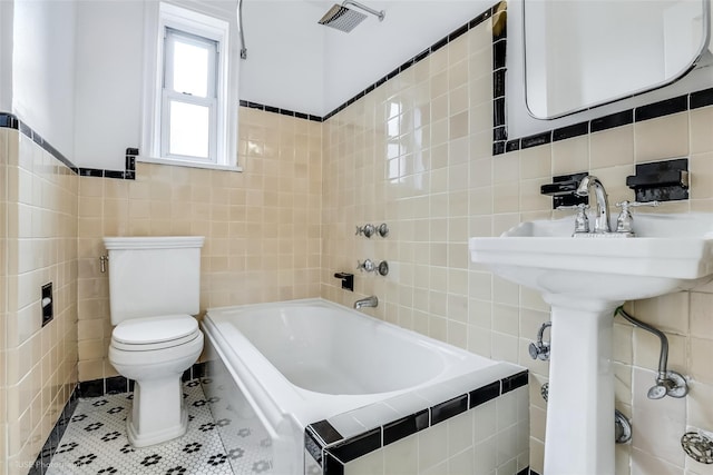 48-55 43rd St Unit 4H, Woodside, NY 11377 - bathroom with tile walls, a garden tub, and tile patterned floors