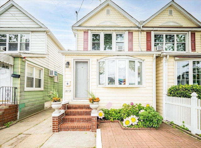 10719 Sutter Ave, Ozone Park, NY 11417 - view of front of home with entry steps and a wall unit AC