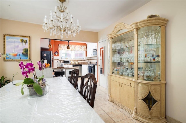 10719 Sutter Ave, Ozone Park, NY 11417 - dining room featuring a chandelier and light tile patterned flooring