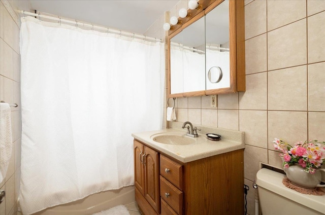 10719 Sutter Ave, Ozone Park, NY 11417 - bathroom featuring vanity, tile walls, shower / bath combo with shower curtain, and decorative backsplash