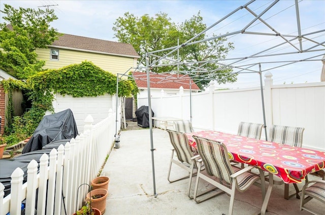 10719 Sutter Ave, Ozone Park, NY 11417 - fenced backyard featuring a grill, a garage, and a patio