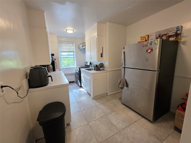 1234MIDLAND Ave Ave Unit 1C, Bronxville, NY 10708 - kitchen featuring appliances with stainless steel finishes, radiator heating unit, light countertops, white cabinets, and light tile patterned floors