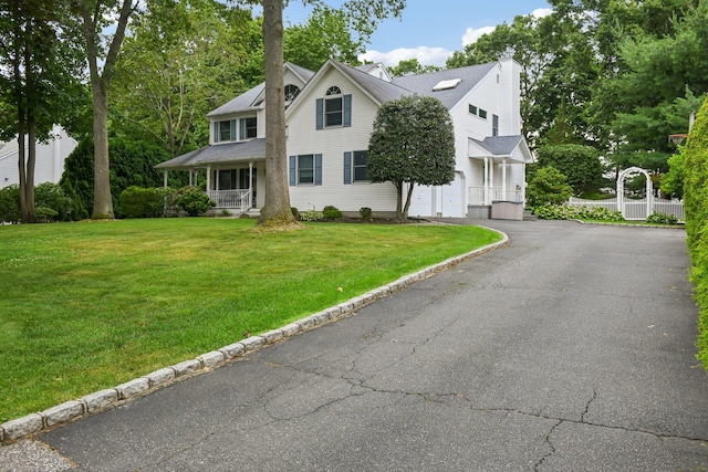 5 Aspen Cir, Saint James, NY 11780 - view of front facade with driveway, covered porch, a front lawn, and a chimney