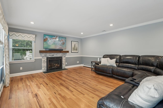 5 Aspen Cir, Saint James, NY 11780 - living area with a baseboard heating unit, light wood finished floors, recessed lighting, a stone fireplace, and ornamental molding