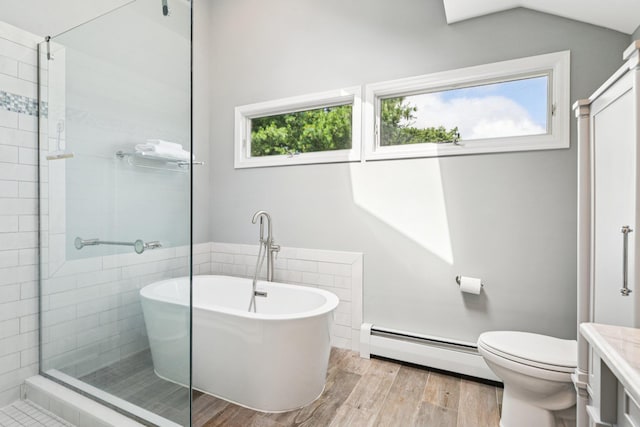 5 Aspen Cir, Saint James, NY 11780 - bathroom featuring a baseboard heating unit, a freestanding tub, wood finished floors, a tile shower, and vaulted ceiling