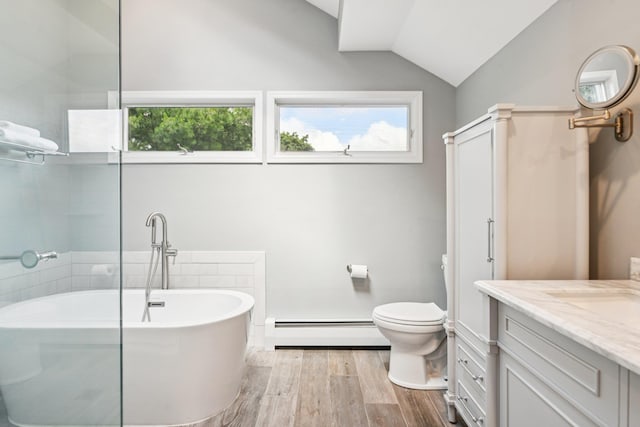 5 Aspen Cir, Saint James, NY 11780 - bathroom with a baseboard radiator, vaulted ceiling, vanity, wood finished floors, and a freestanding bath