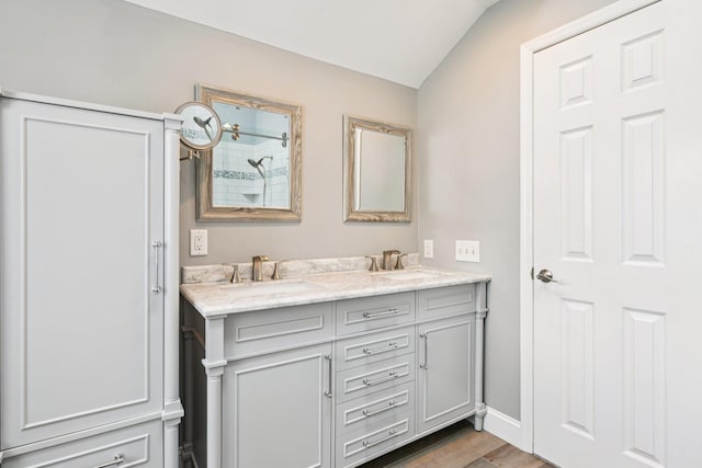 5 Aspen Cir, Saint James, NY 11780 - bathroom featuring double vanity, vaulted ceiling, wood finished floors, and a shower