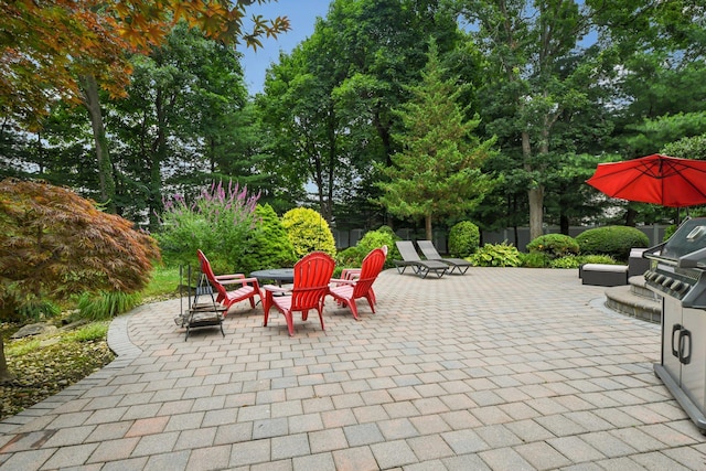 5 Aspen Cir, Saint James, NY 11780 - view of patio with a fire pit and view of wooded area
