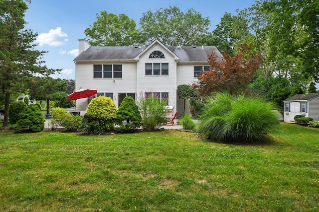 5 Aspen Cir, Saint James, NY 11780 - traditional-style house with a chimney, a front lawn, and an outdoor structure