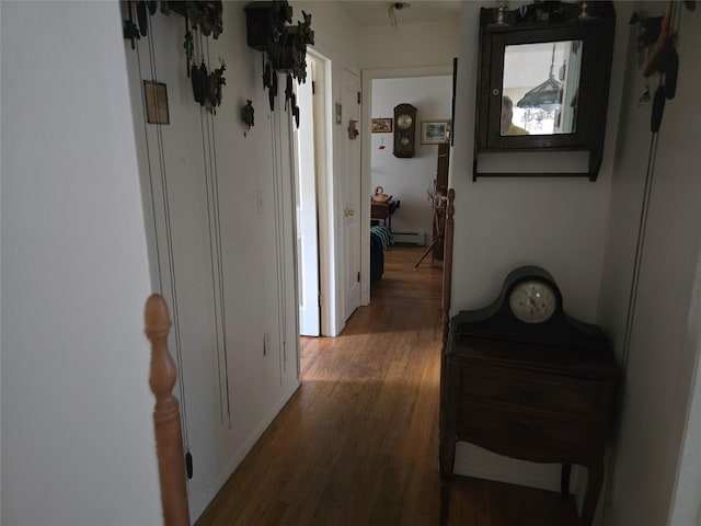 27 Leo Ln, Deer Park, NY 11729 - hall with a baseboard heating unit and wood finished floors