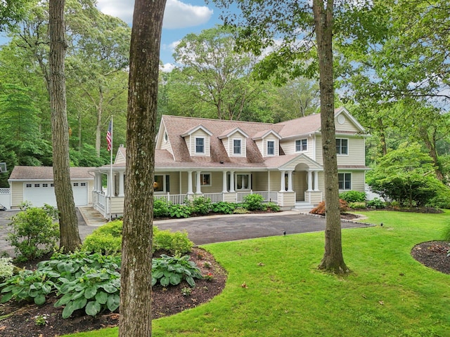 23 Alpine Way S, Huntington, NY 11746 - view of front of home with a garage, a porch, asphalt driveway, a front yard, and an outbuilding